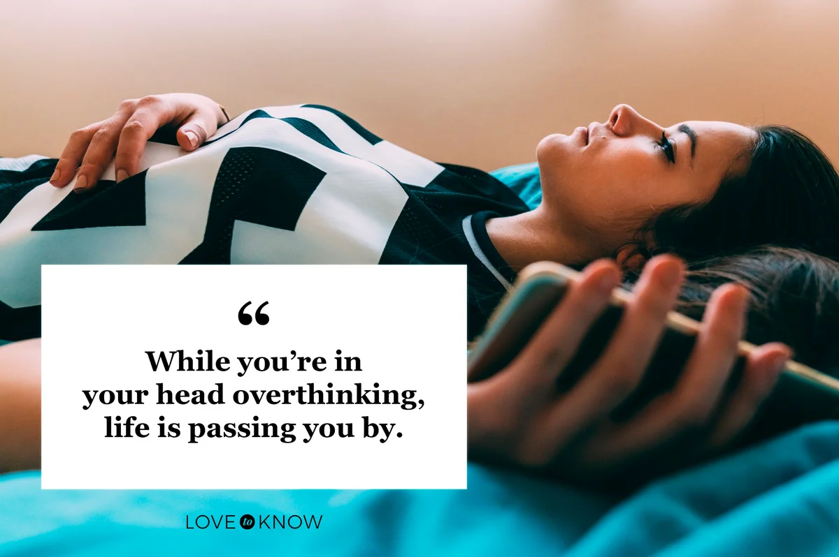 woman laying on bed overthinking life