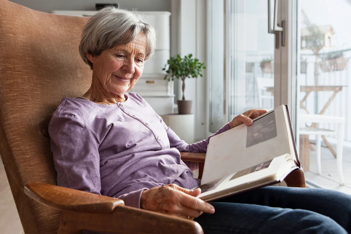 woman looking at old photo album