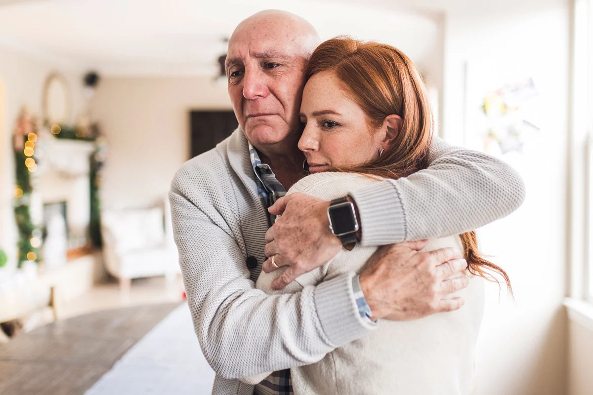 father comforting daughter missing mother on Mothers Day