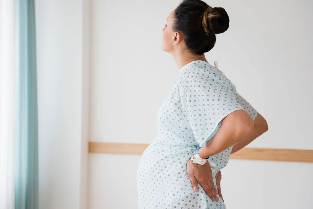 pregnant woman in early labor standing up