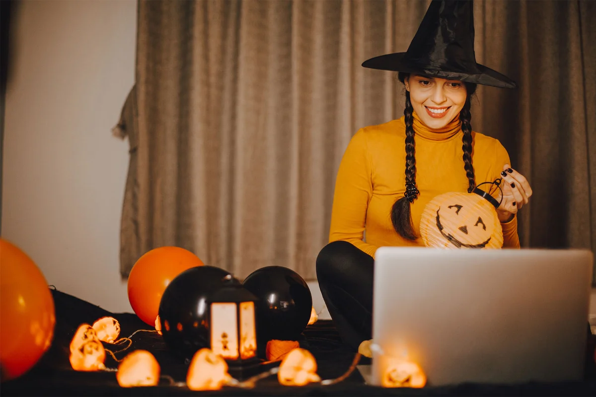 remote employee in Halloween costume in front of computer