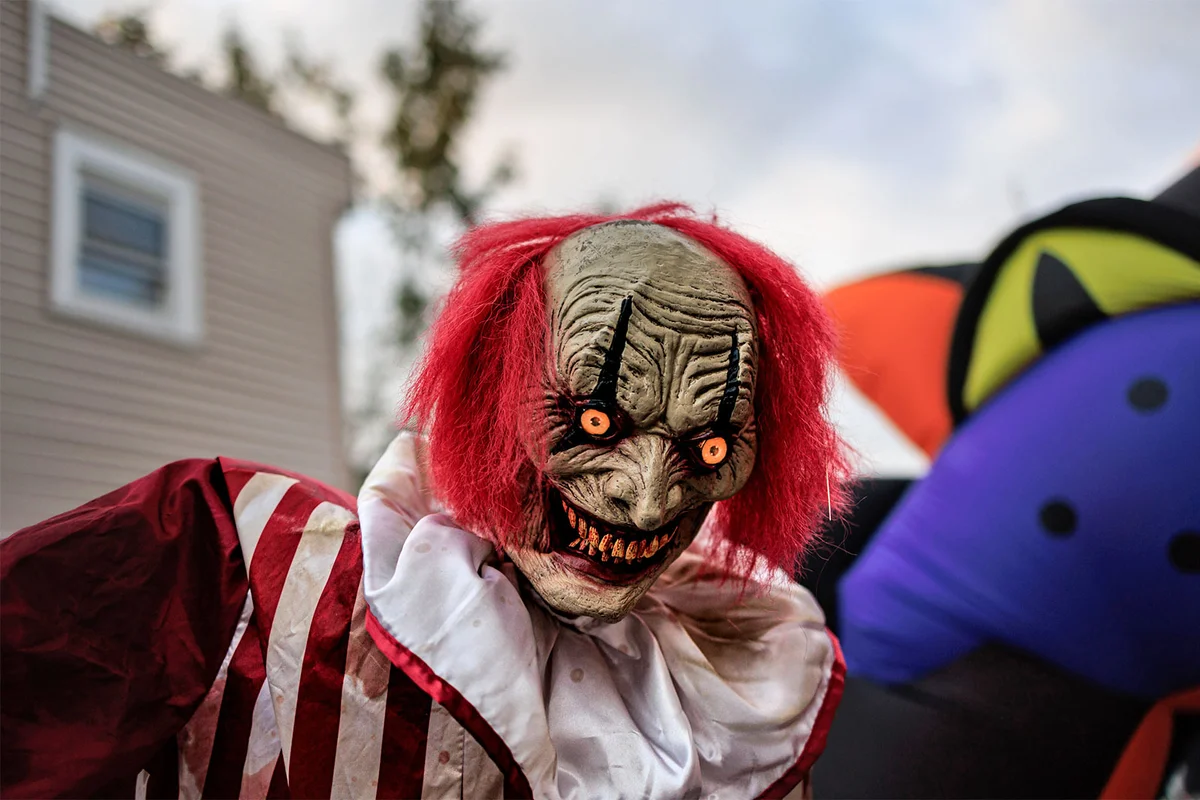 Zombie clown at outdoor Halloween party