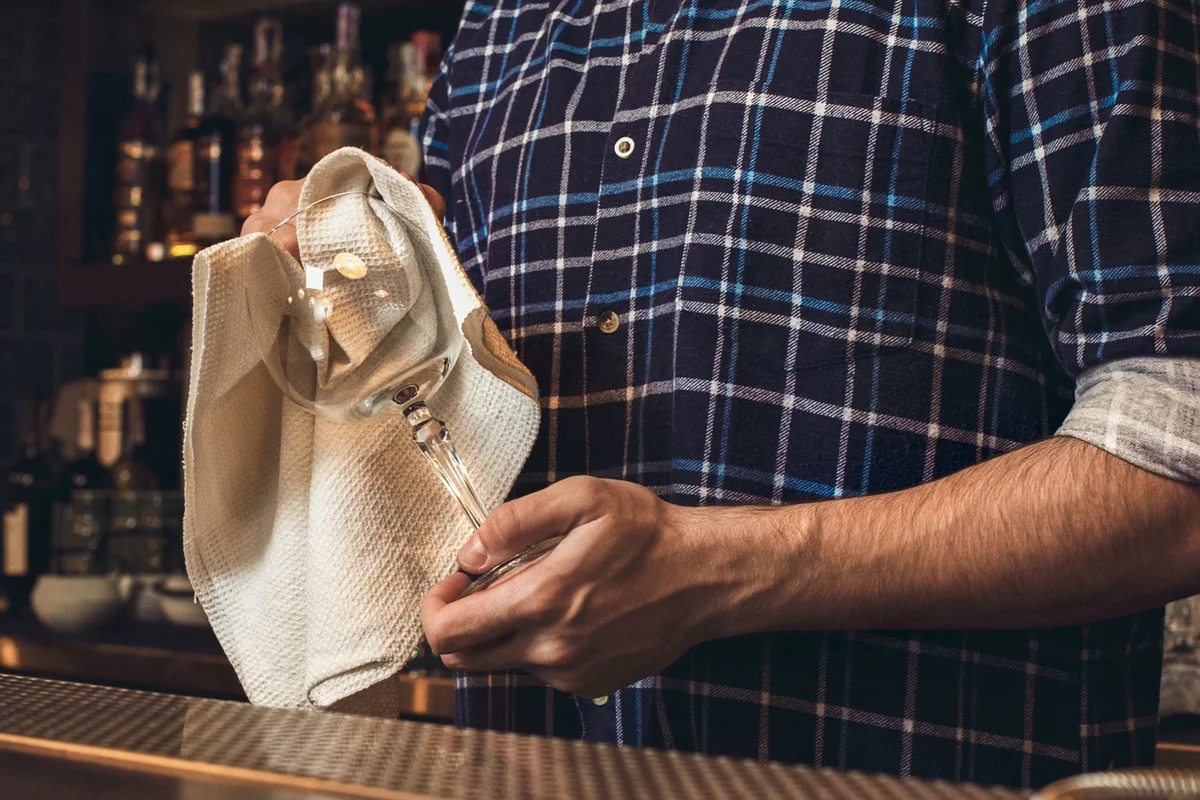 Barback cleaning wine glasses