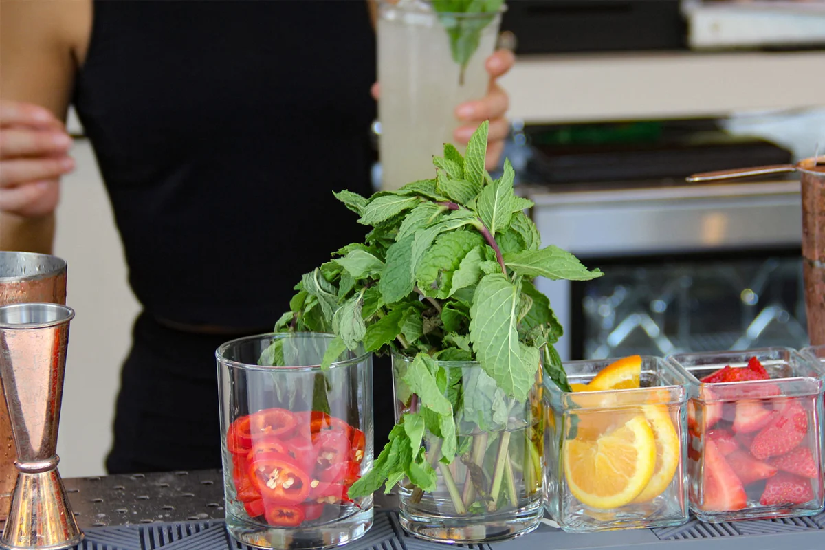 Barback preparing cocktail garnishes
