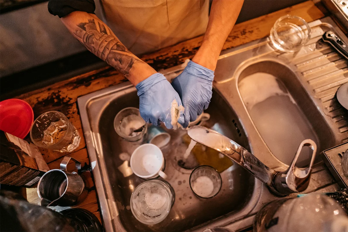 Barback washing dishes and glassware