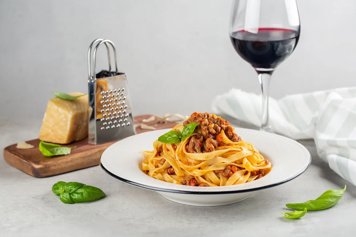 pasta tagliatelle with bolognese sauce made from meat and tomato sauce, parmesan cheese and red wine