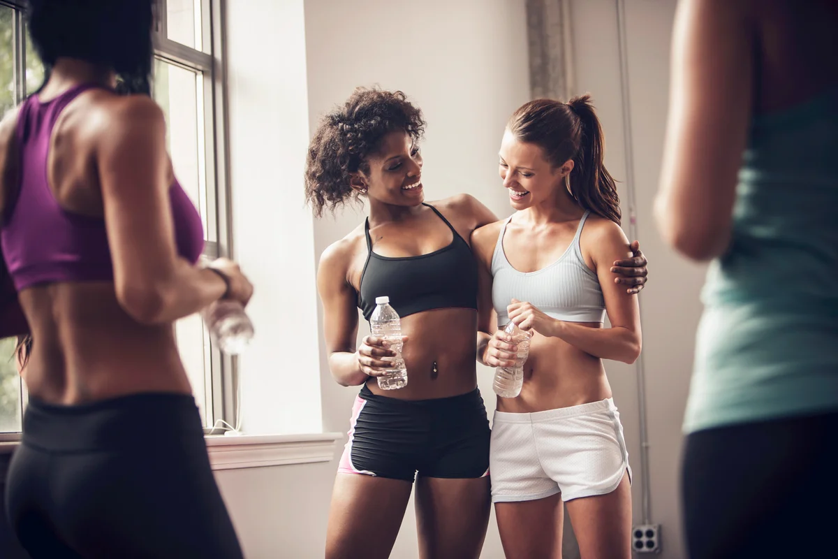 Women talking and being supportive in gym