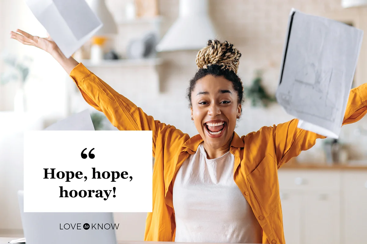 Excited happy young woman scattering documents in the office