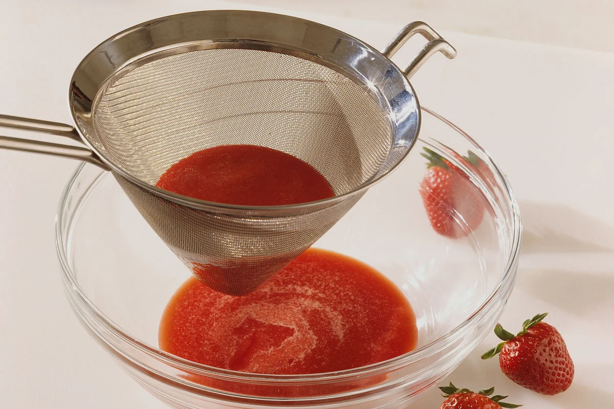wire mesh strainer with strawberry puree for cocktails
