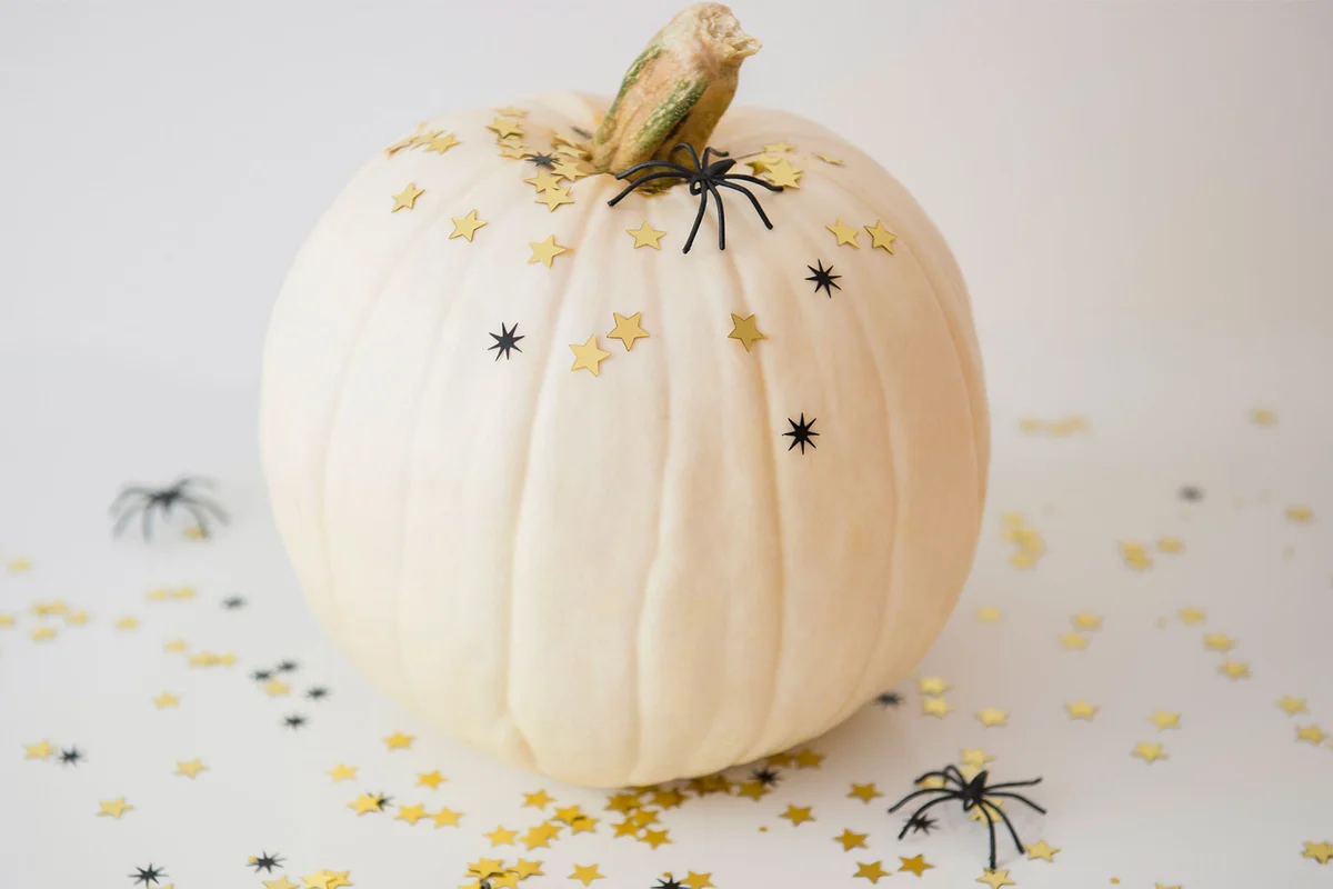 white pumpkin with spiders Halloween table decoration