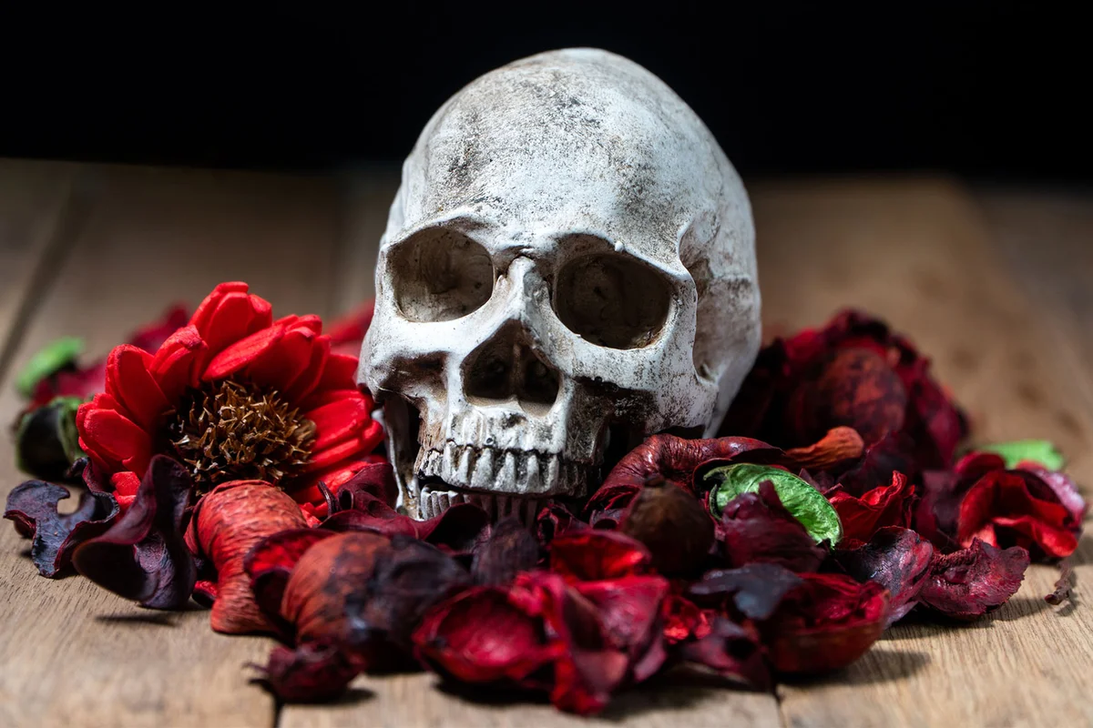 skull and red flowers for Halloween table decoration