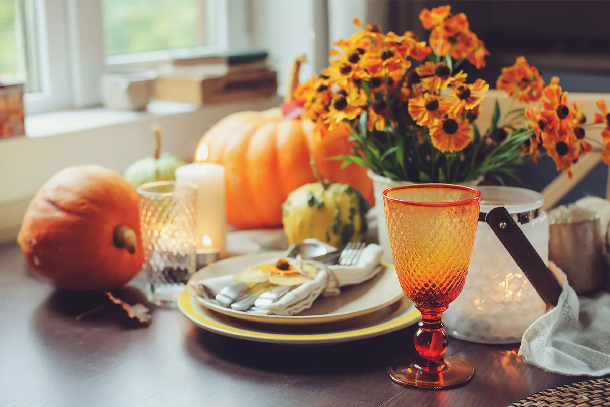 orange flowers and gourds for Halloween table setting