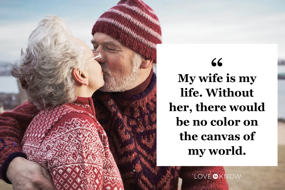 Older couple kissing on beach