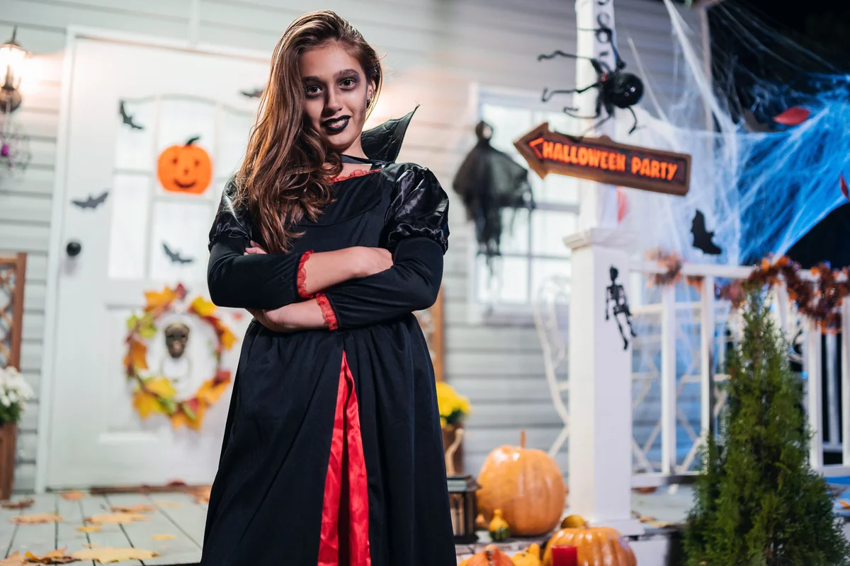Girl in vampire costume having fun on Halloween party