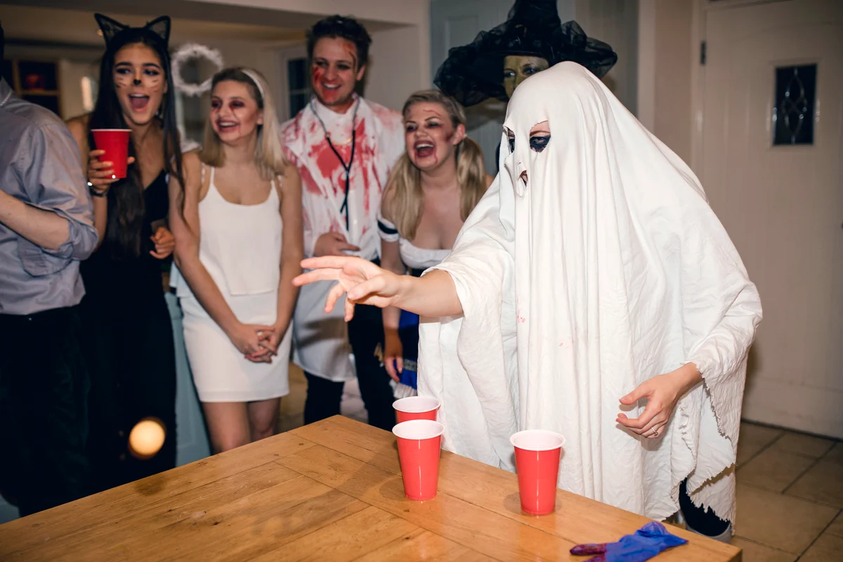 Friends dressed up in costumes for Halloween while playing games