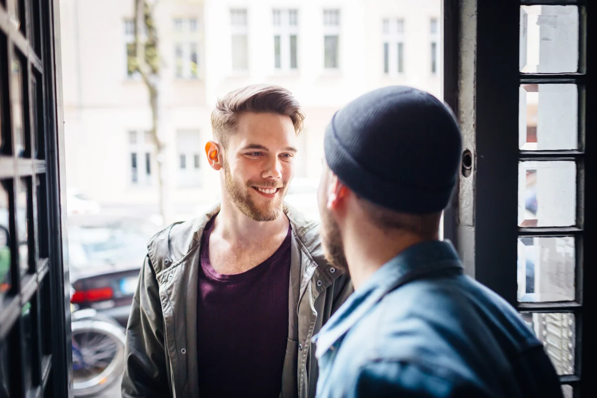 Couple greeting each other at their door