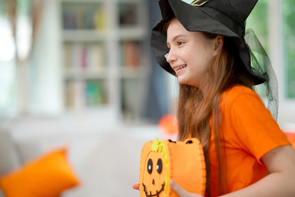 Cute girl holding up the Pumpkin