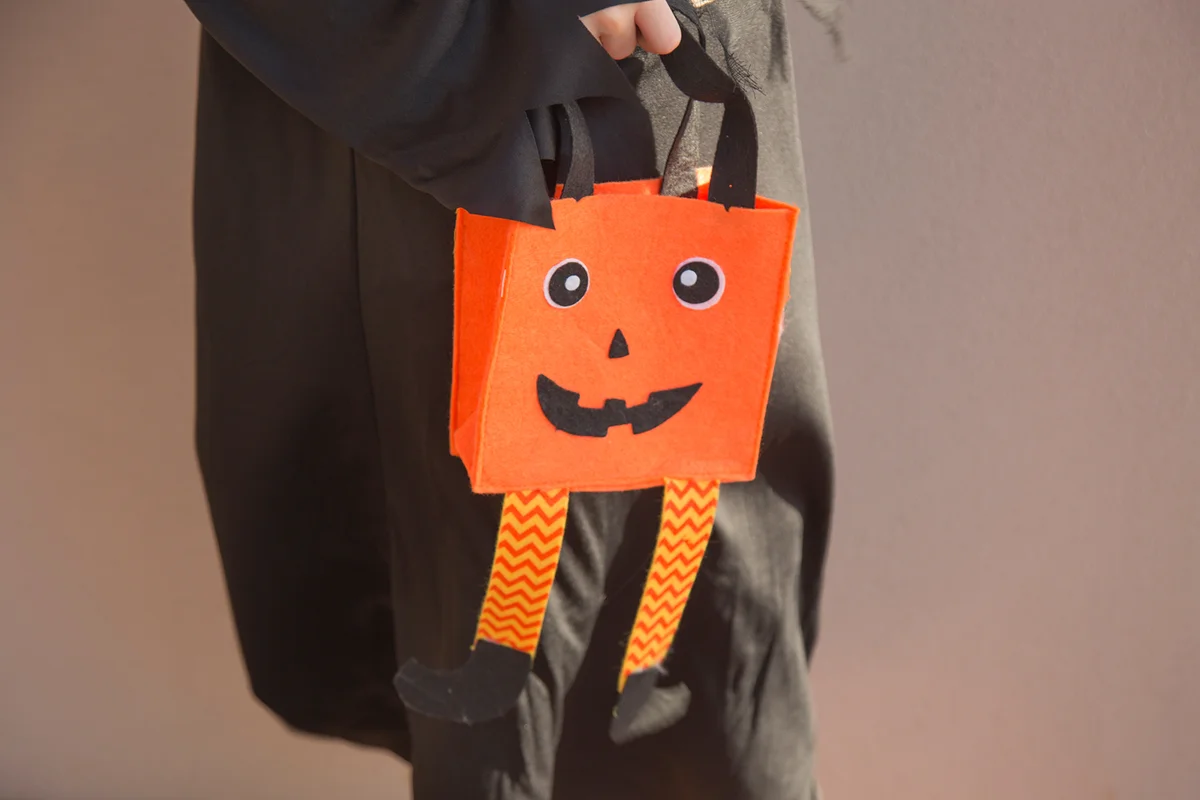 A child trick-or-treating in a scary costume at Halloween