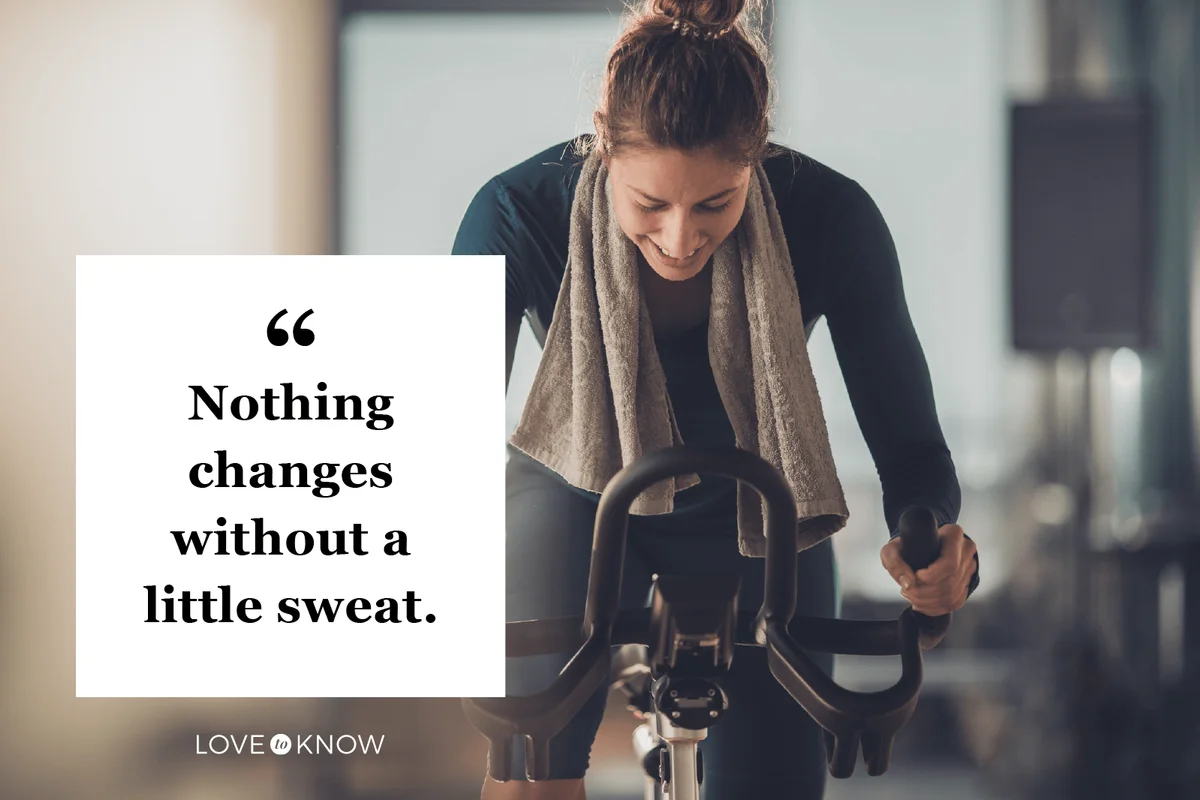 Happy athletic woman cycling on exercise bike in a gym
