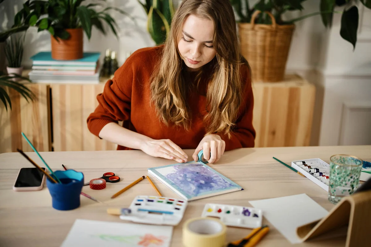 woman creating beautiful watercolor design.