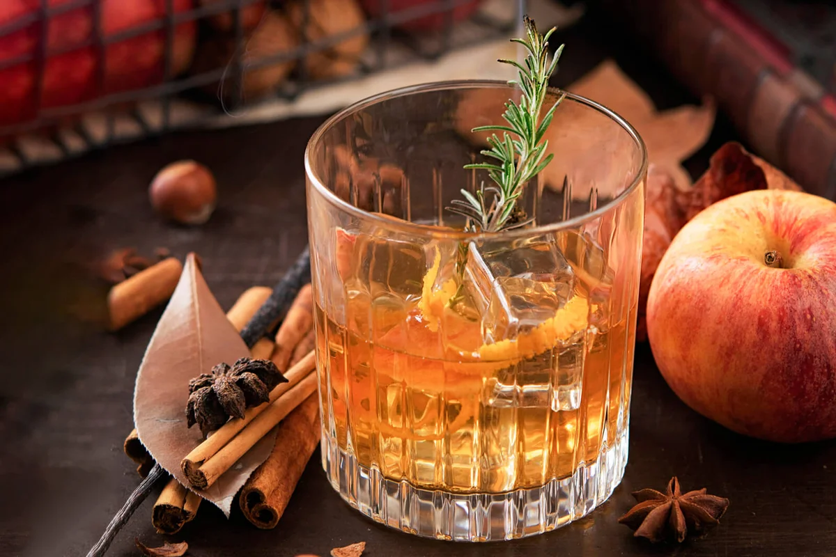 Glass of whisky with smoking rosemary