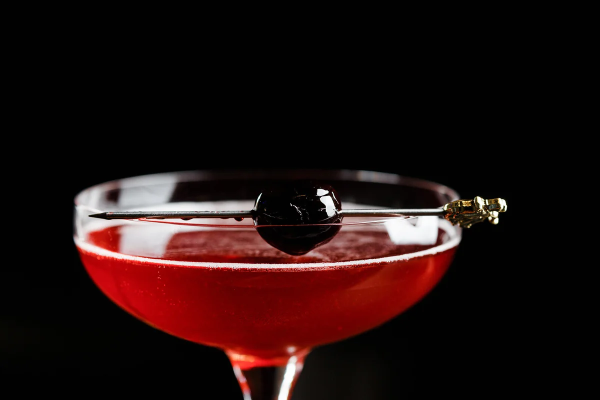 Alcoholic drink in glass with cherry