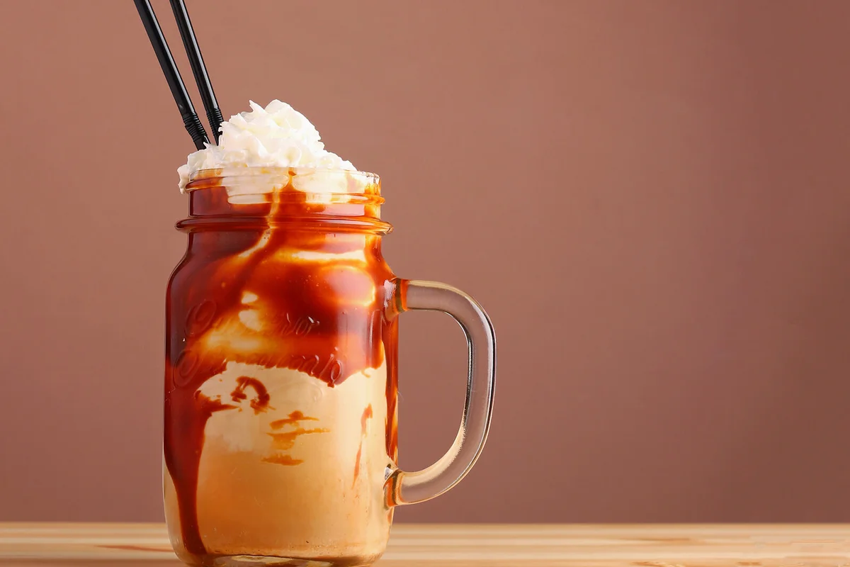 Caramel milkshake with coffee on wooden table | Photo 178726831 © Aleksei Tsekanov | Dreamstime.com
