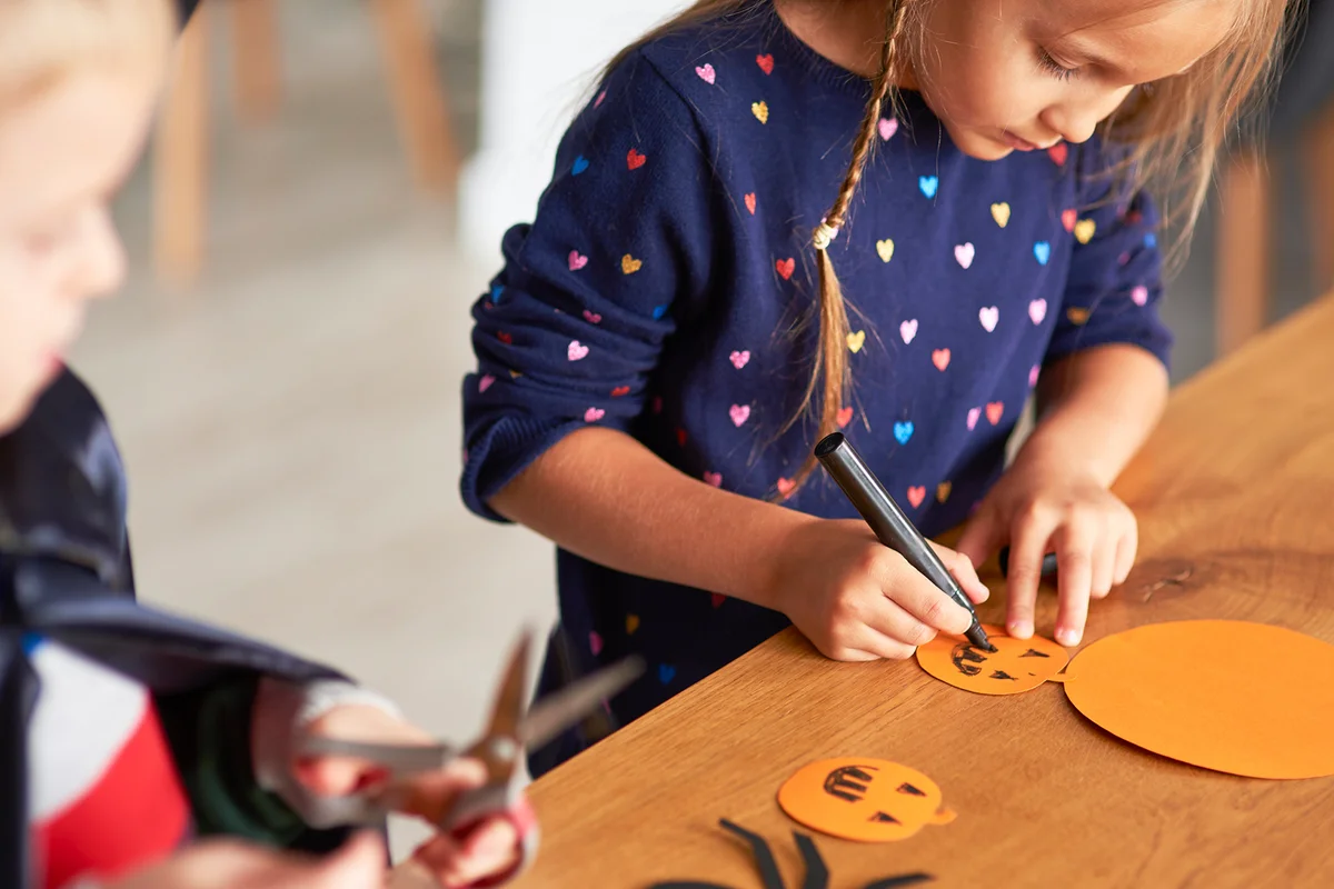 Cute girl preparing halloween signs