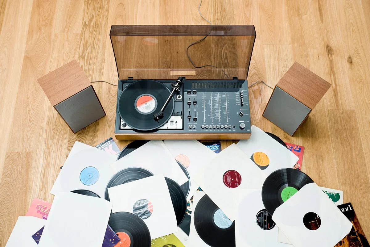 Records lying on floor by 1970's stereo system