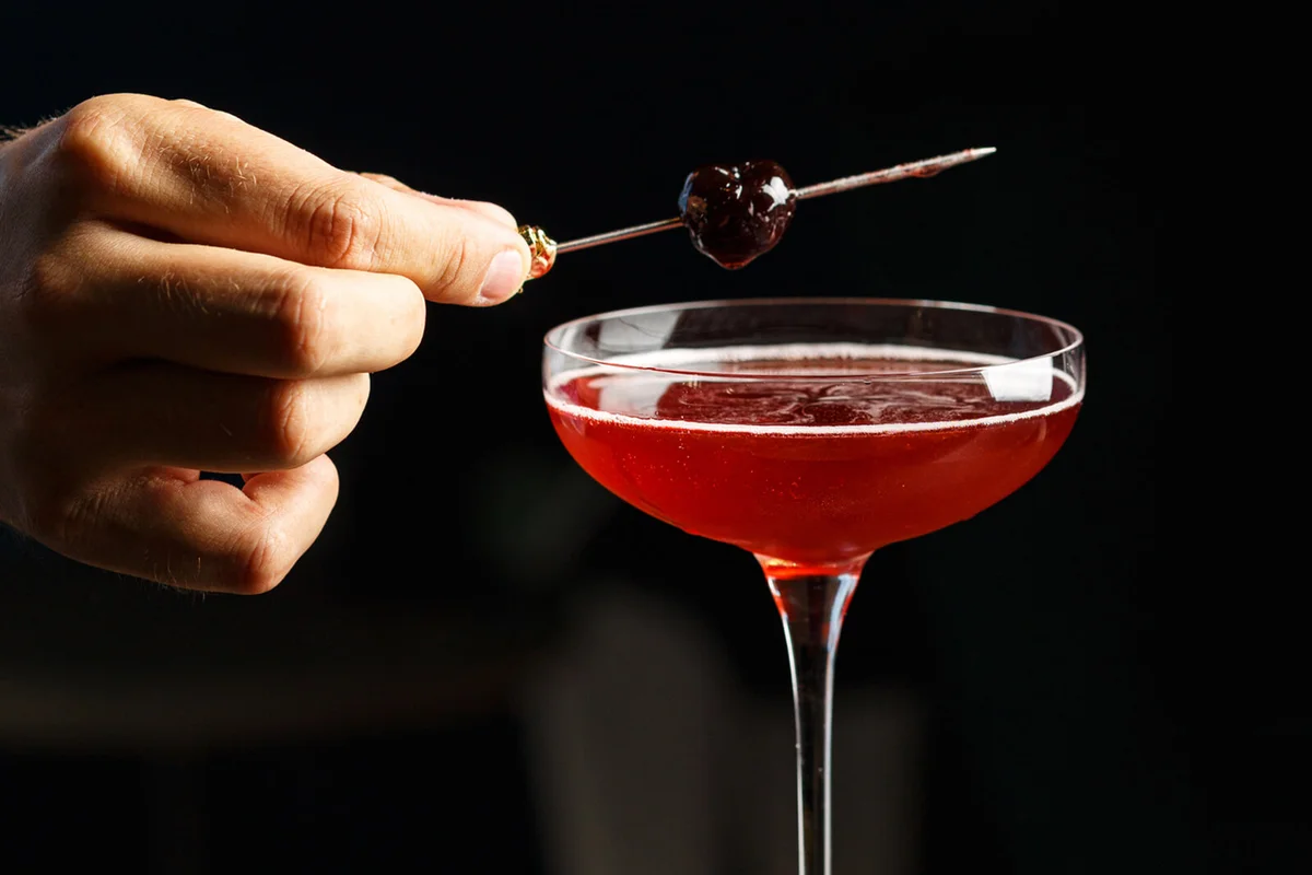 Alcoholic drink in glass with cherry