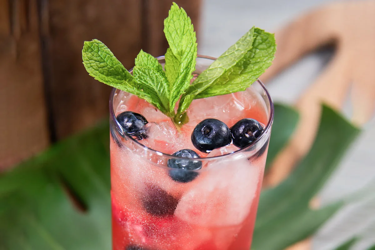 Red cocktail with blue berries