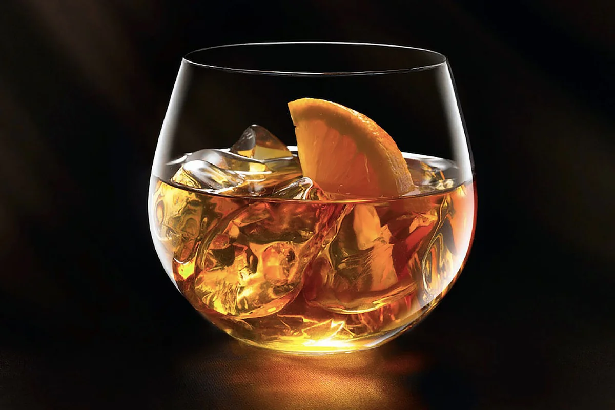 whiskey on the rock with an orange wedge
