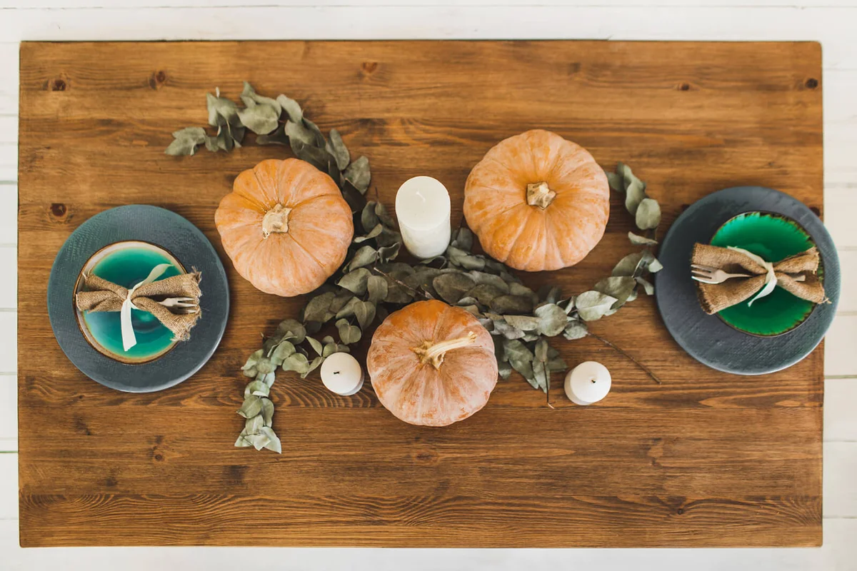 Fall themed holiday table setting arrangement for a seasonal party