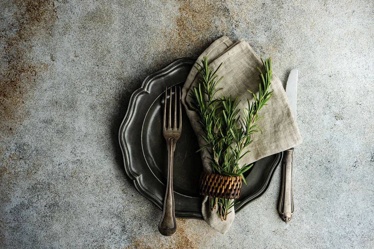 Rustic table setting with fresh rosemary decoration