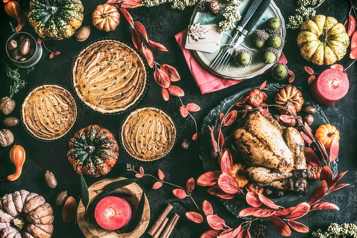 Thanksgiving day dinner table with pumpkin pie