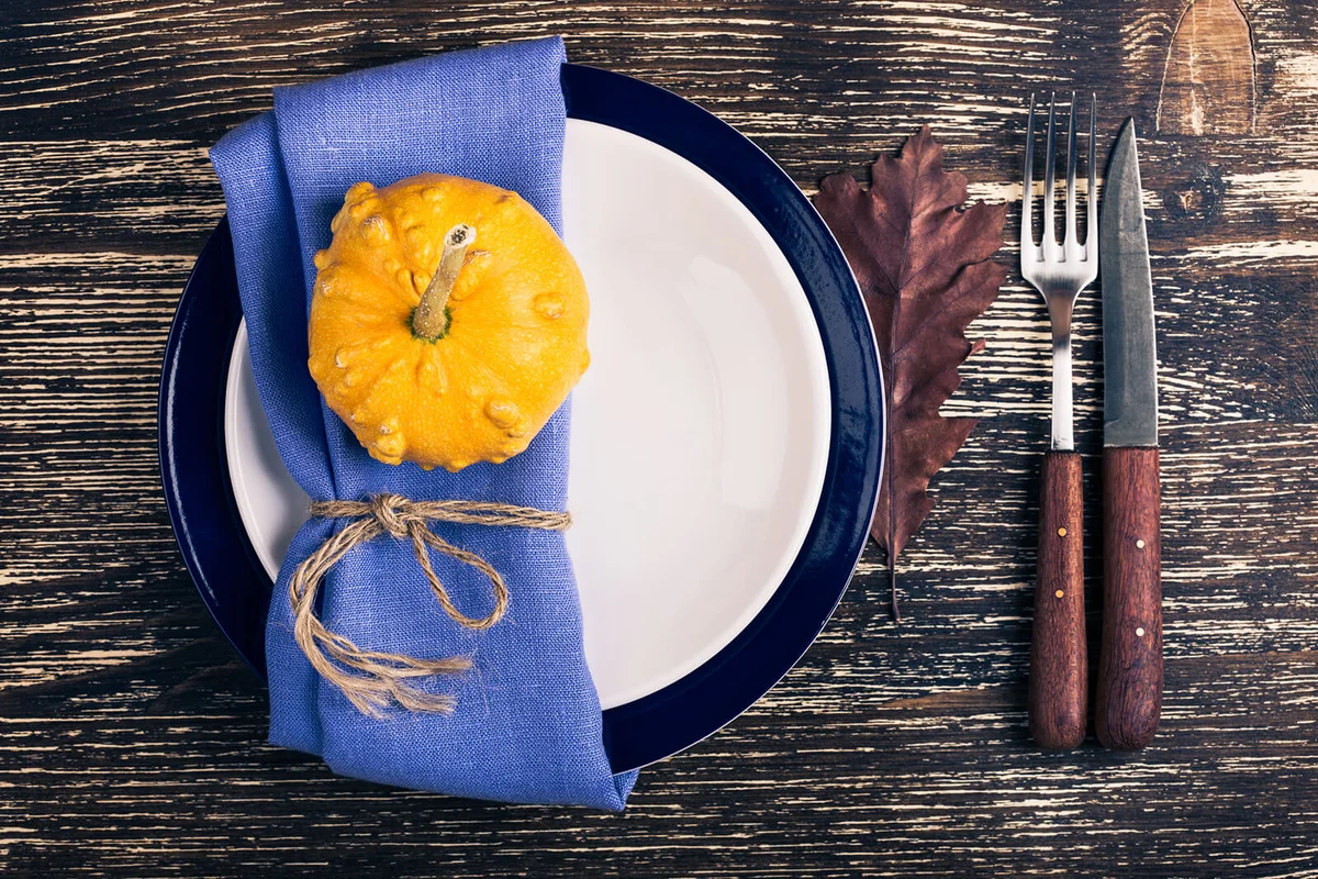 Rustic autumn place setting with miniature pumpkin