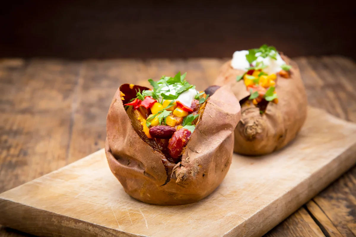 Sweet potato kumpir with chili con carne, sour cream and coriander