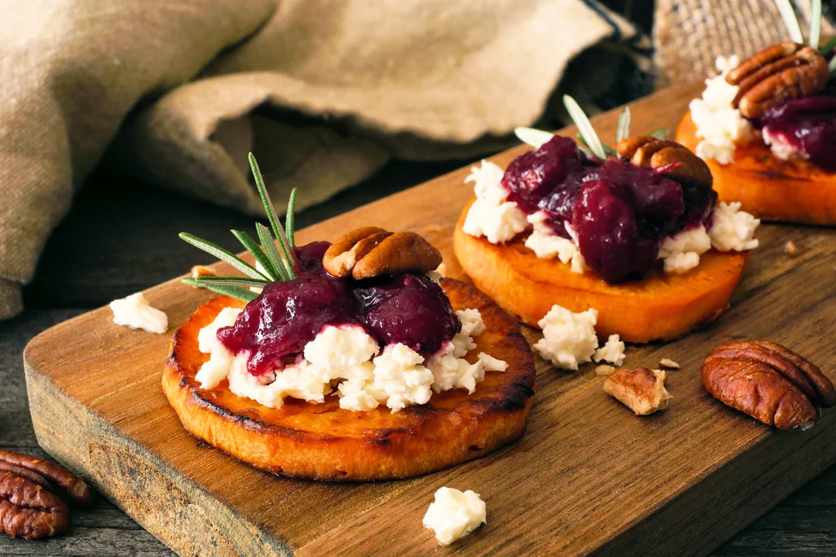 Autumn sweet potato crostini appetizers with cheese, cranberries and pecans