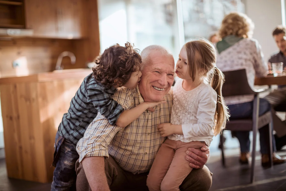 Grandfather playing with his grandkids at Thanksgiving