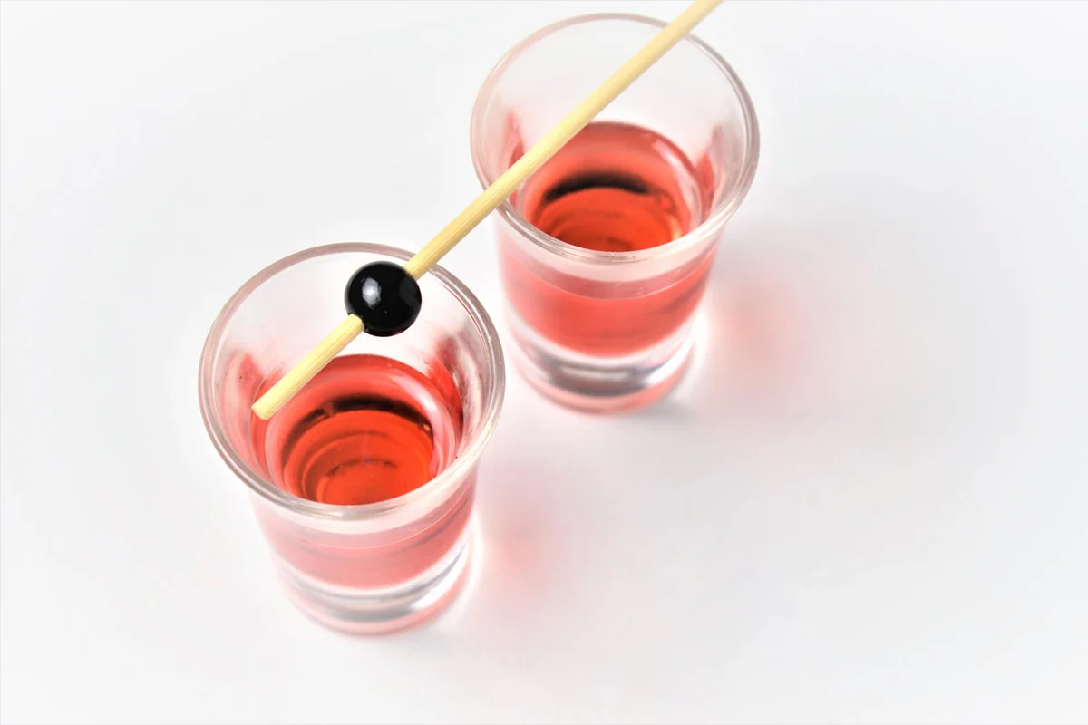 Two glasses of berry liqueur