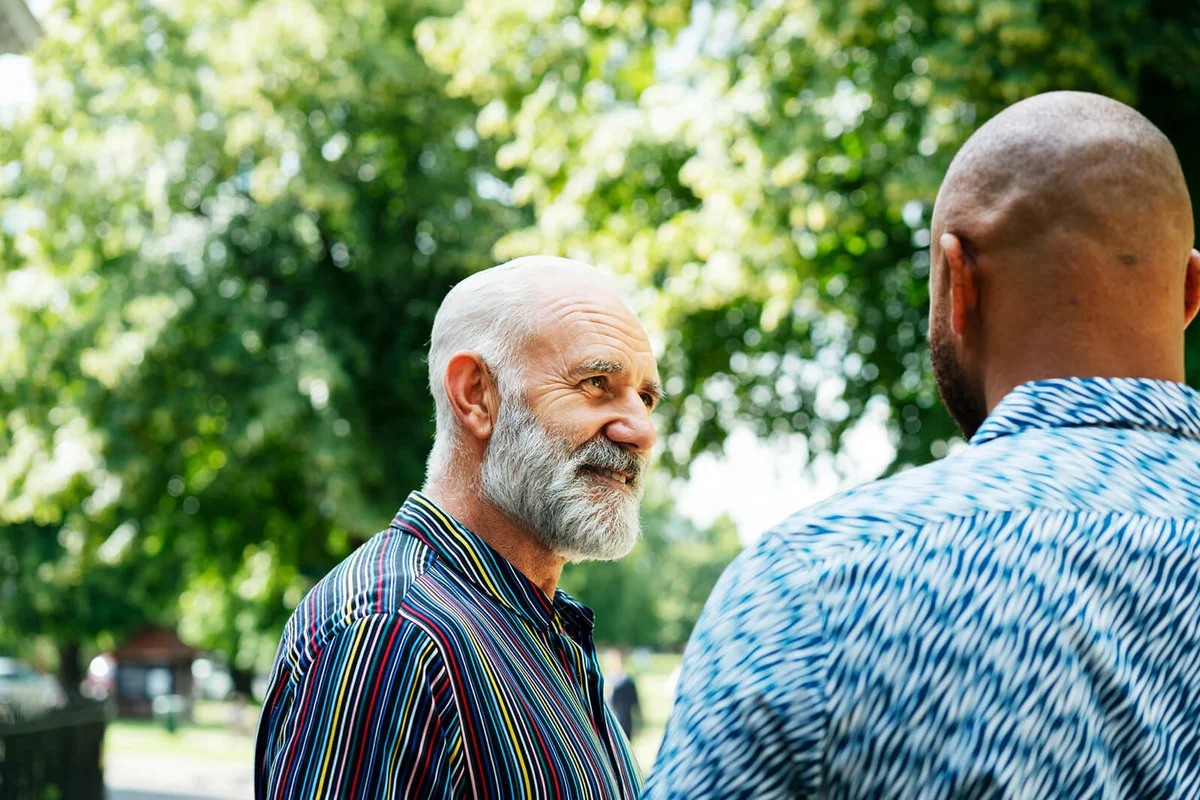 Two men talking and listening