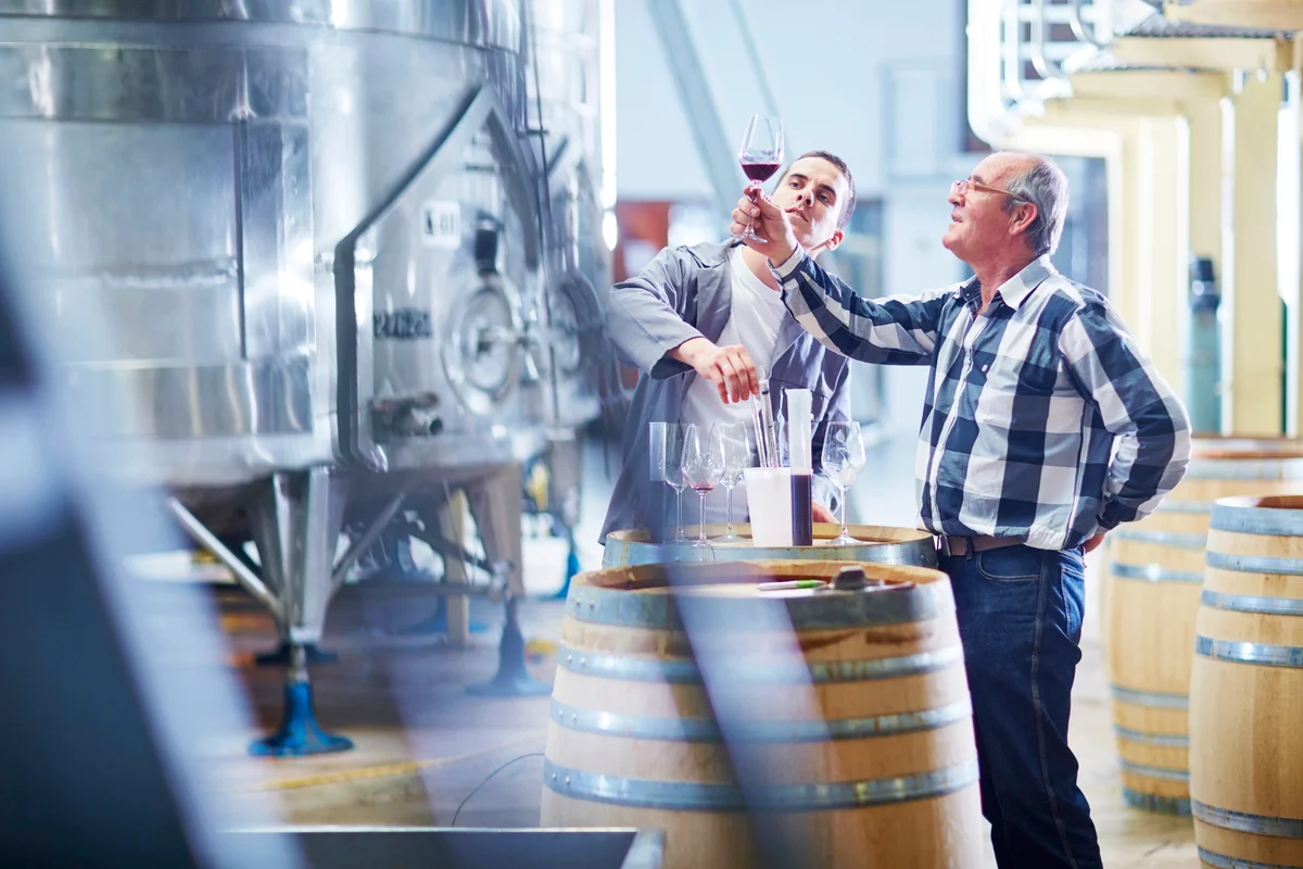 Wine makers testing wine blend