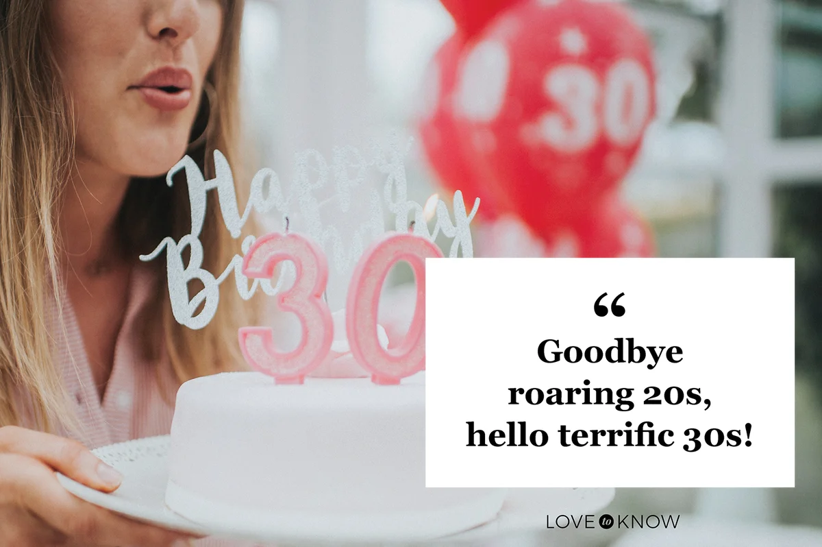 Woman holding candles on cake with 30th cake toppers