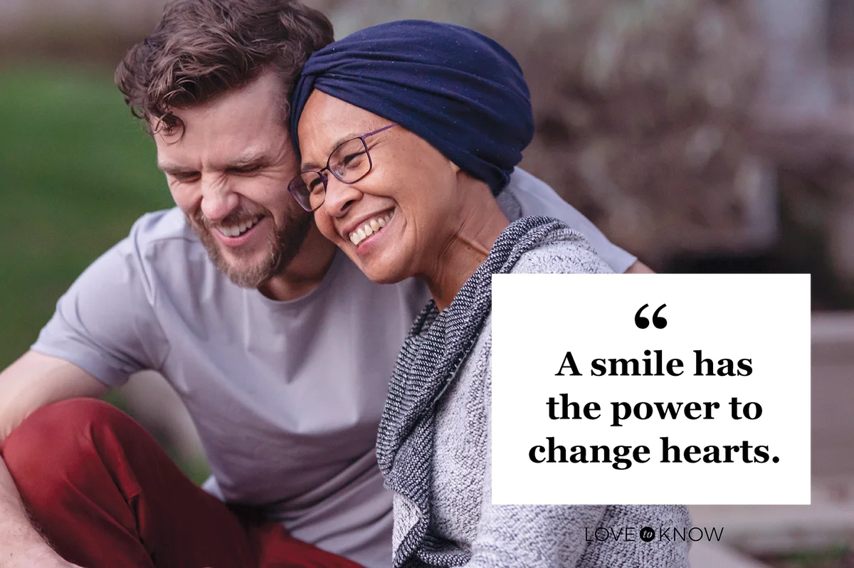 Woman with cancer embracing her adult son, both smiling