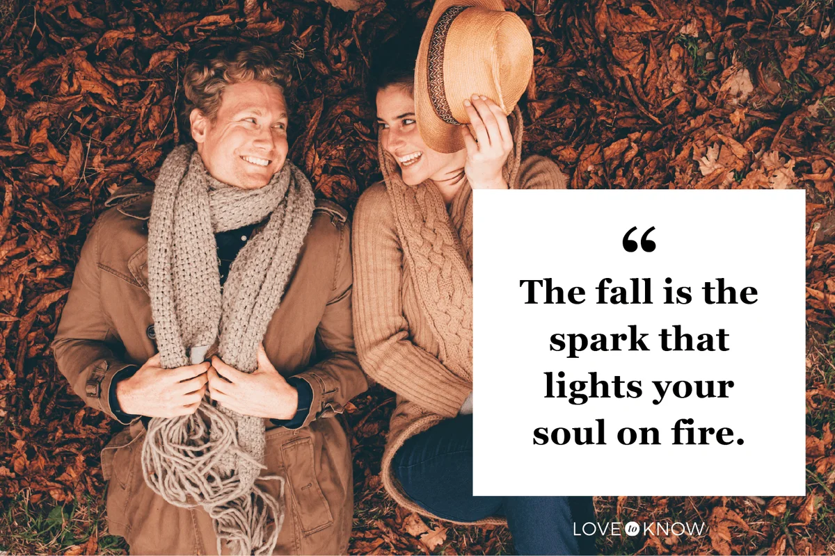 Young couple lying side by side on autumn leaves in an park