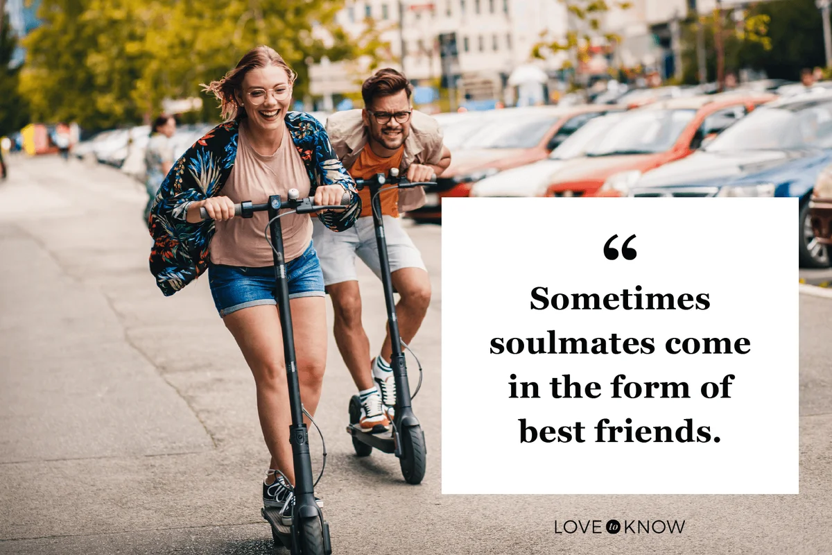 Young couple on vacation having fun driving electric scooter through the city