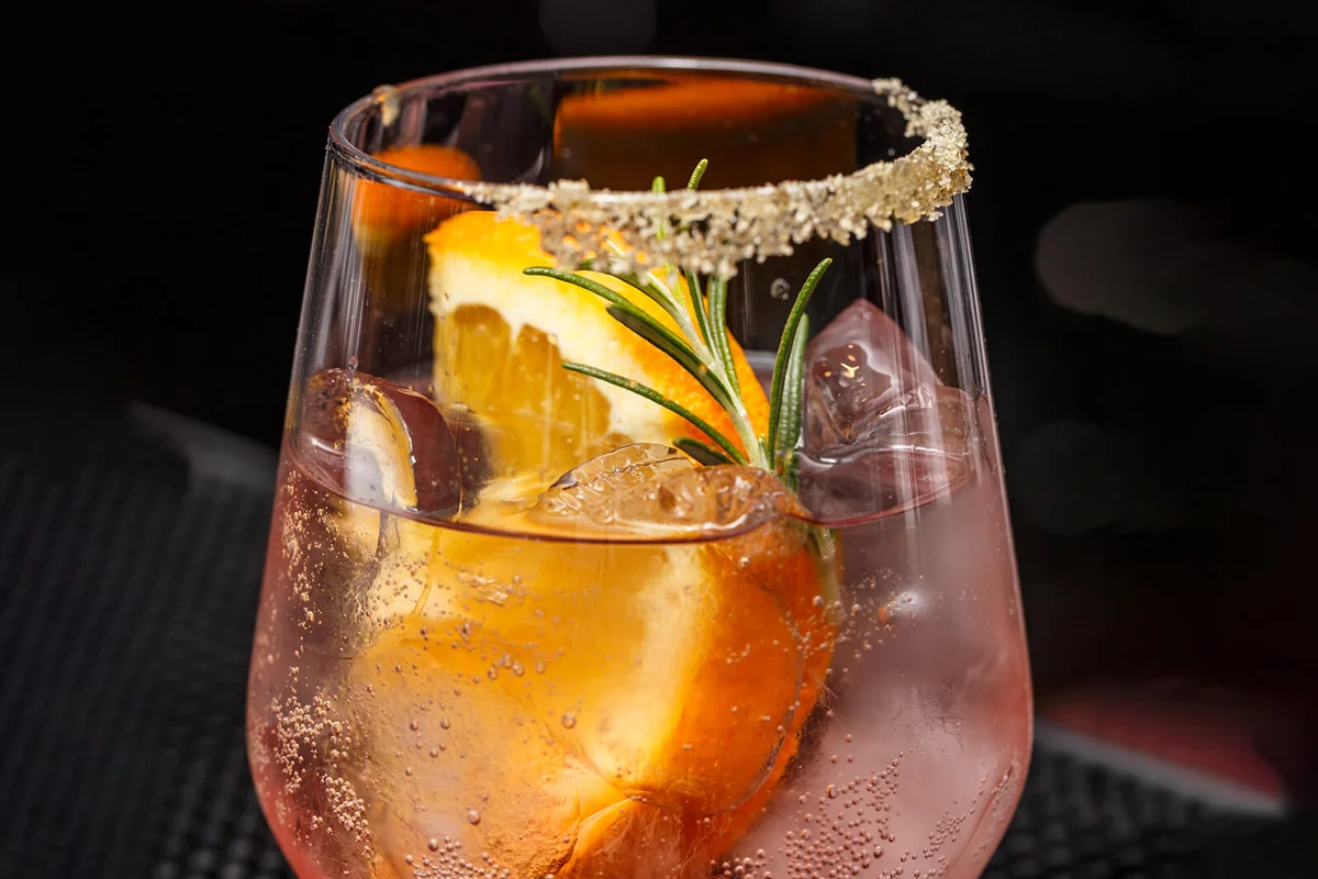 Fresh pomegranate drink with ice and orange
