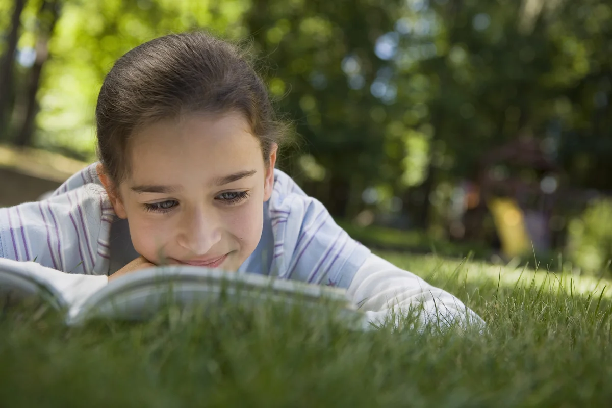girl reading printed book