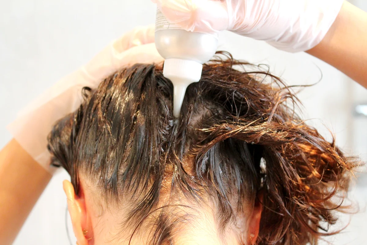 Women doing herself hair color