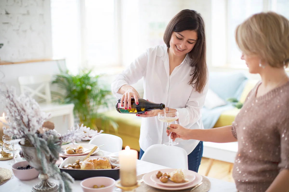 Young women servicing table for Thanksgiving dinner